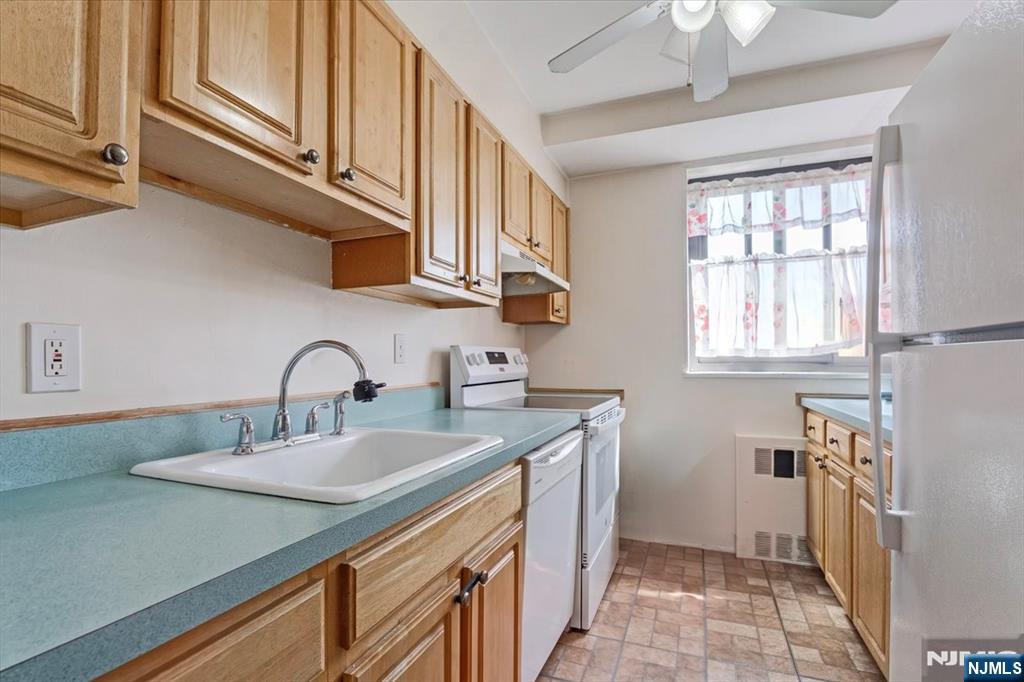 90 Prospect Avenue, Unit 7A Hackensack, NJ 07601 - Photo 5 of 21 a kitchen with stainless steel appliances granite countertop a sink and cabinets