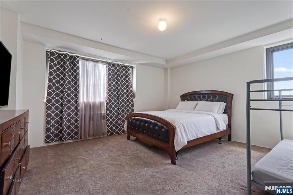 90 Prospect Avenue, Unit 7A Hackensack, NJ 07601 - Photo 7 of 21 a bedroom with a bed and a window