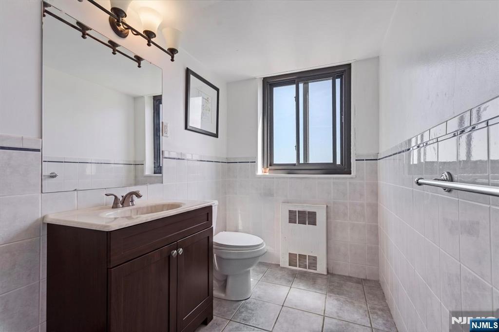 90 Prospect Avenue, Unit 7A Hackensack, NJ 07601 - Photo 8 of 21 a bathroom with a sink toilet and mirror