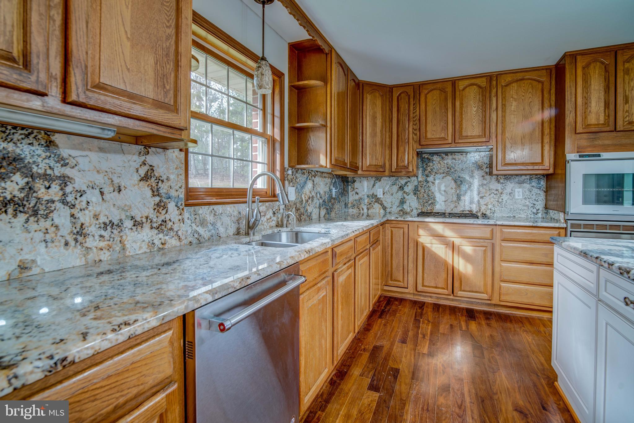 49530 Will's Road Dameron, MD 20628 - Photo 6 of 51 a kitchen with stainless steel appliances granite countertop wooden cabinets a sink and dishwasher a stove with wooden floor