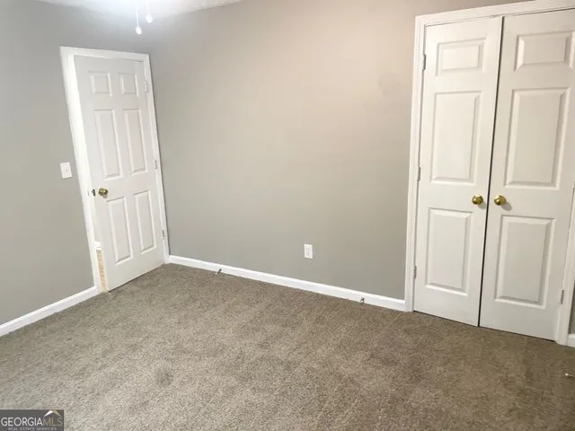an empty room with closet area