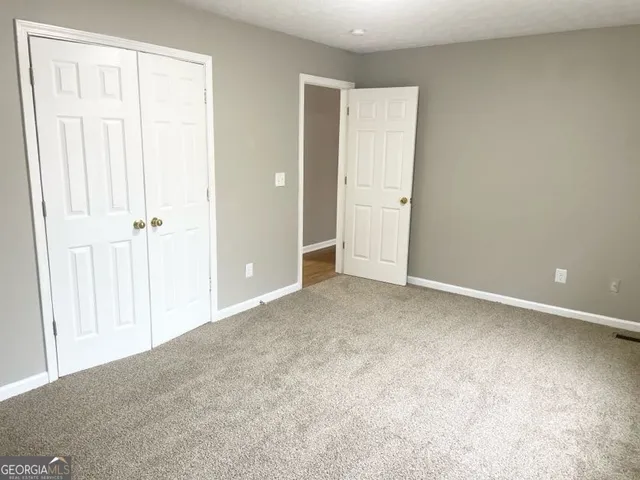 an empty room with closet area