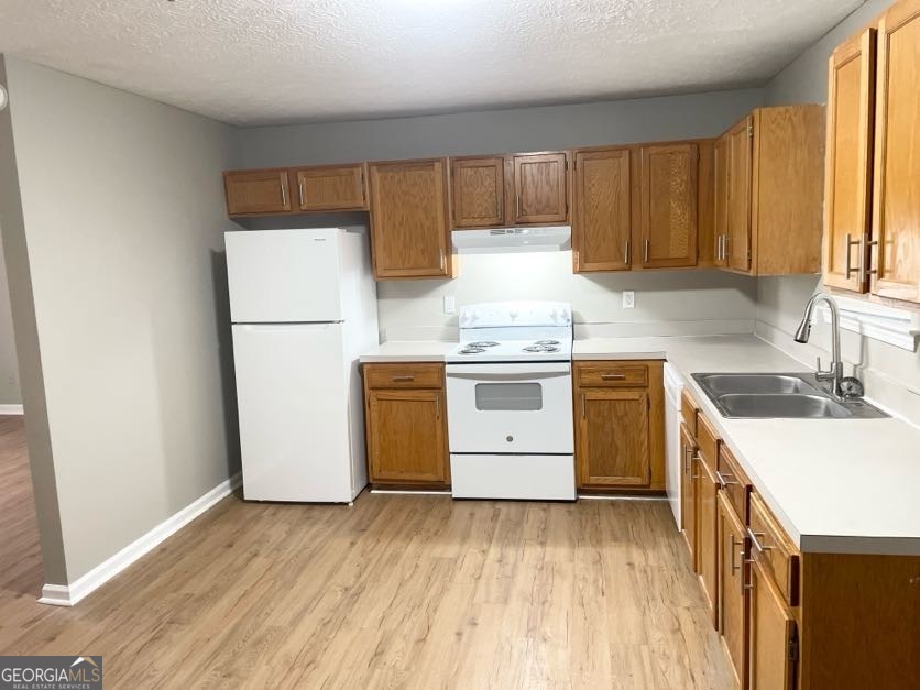 111 West Burke Street, Unit C1 Stockbridge, GA 30281 - Photo 5 of 17 a kitchen with a stove a sink and a refrigerator
