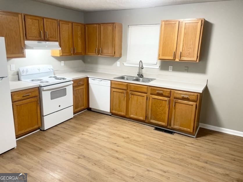 111 West Burke Street, Unit C1 Stockbridge, GA 30281 - Photo 6 of 17 a kitchen with stainless steel appliances granite countertop a sink a stove cabinets and wooden floor