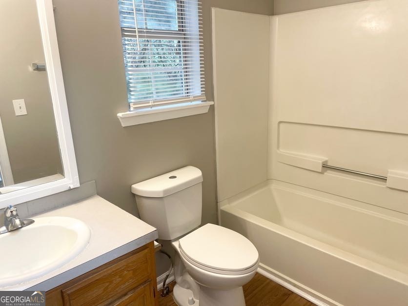 111 West Burke Street, Unit C1 Stockbridge, GA 30281 - Photo 8 of 17 a white toilet sitting next to a bath tub