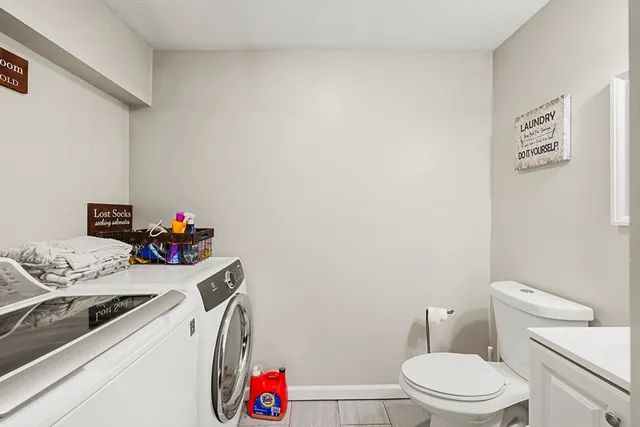 a bathroom with a sink a toilet and a shower curtain