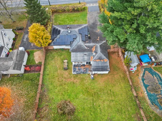 a aerial view of a house with swimming pool garden and patio
