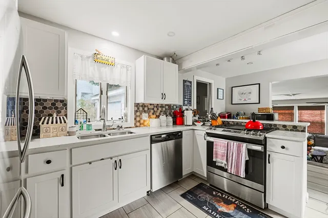 a kitchen that has a sink and a stove in it