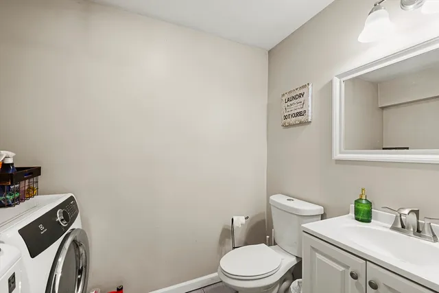 a white toilet sitting next to a bathroom sink