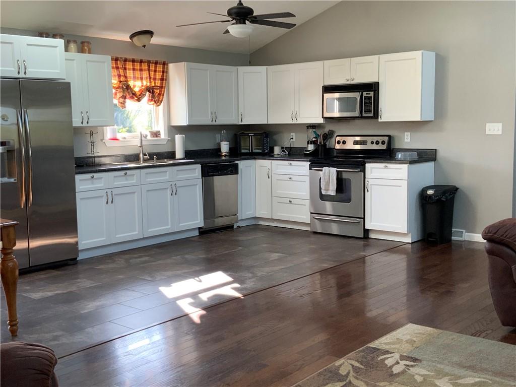 102 Memorial Road West Alexander, PA 15376 - Photo 2 of 19 a kitchen with granite countertop a stove a sink and a refrigerator