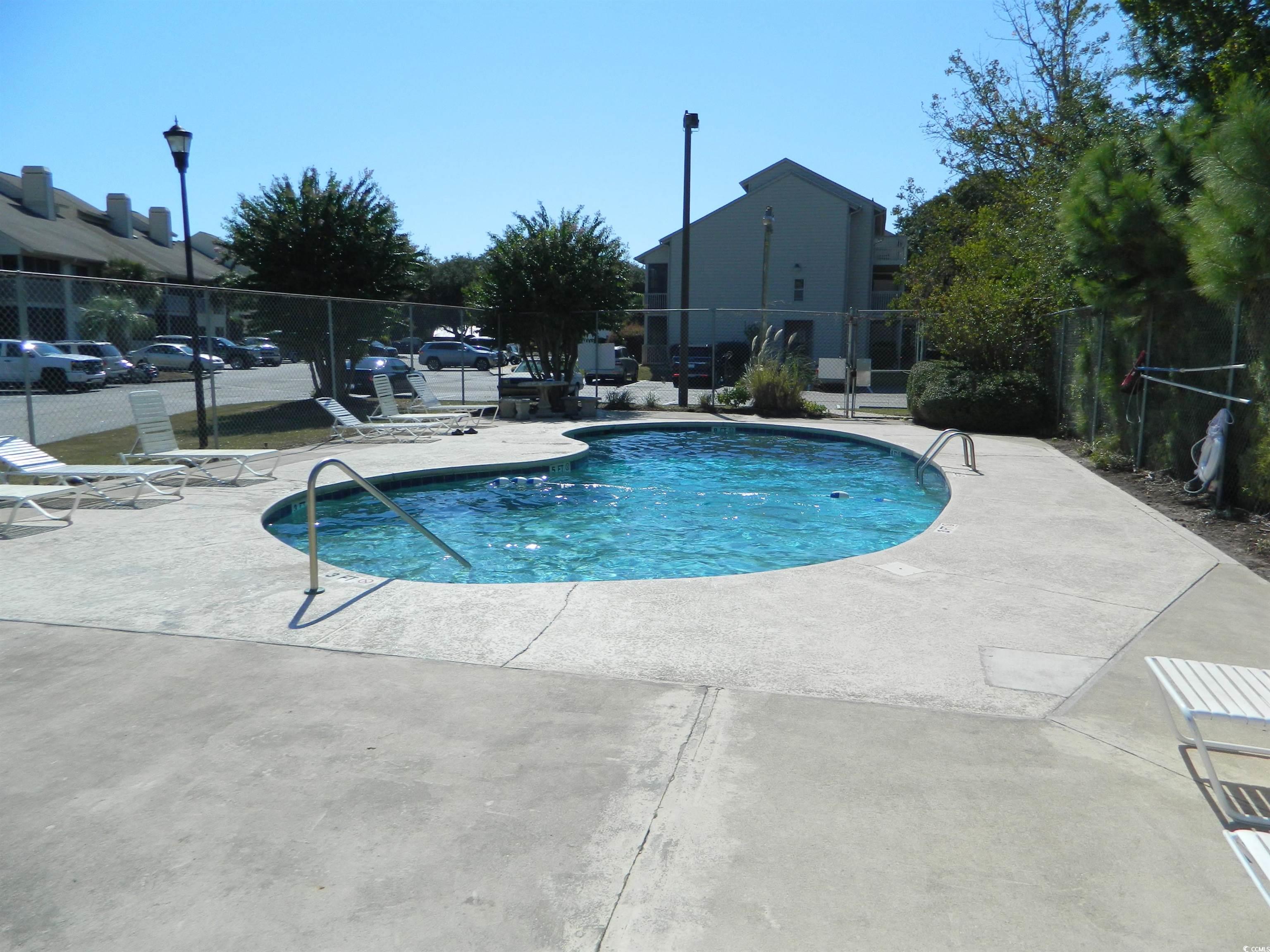 1356 Glenns Bay Road, Unit 103C Surfside Beach, SC 29575 - Photo 15 of 15 Community pool with a patio area