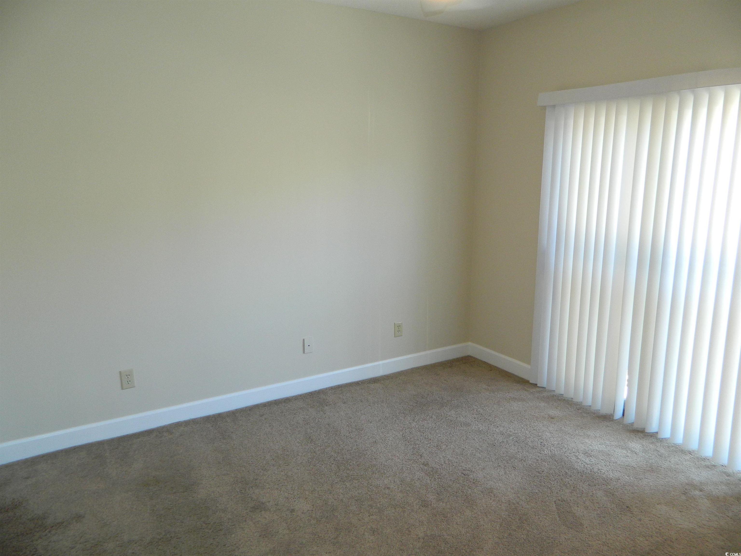 1356 Glenns Bay Road, Unit 103C Surfside Beach, SC 29575 - Photo 8 of 15 Empty room featuring carpet flooring and baseboards