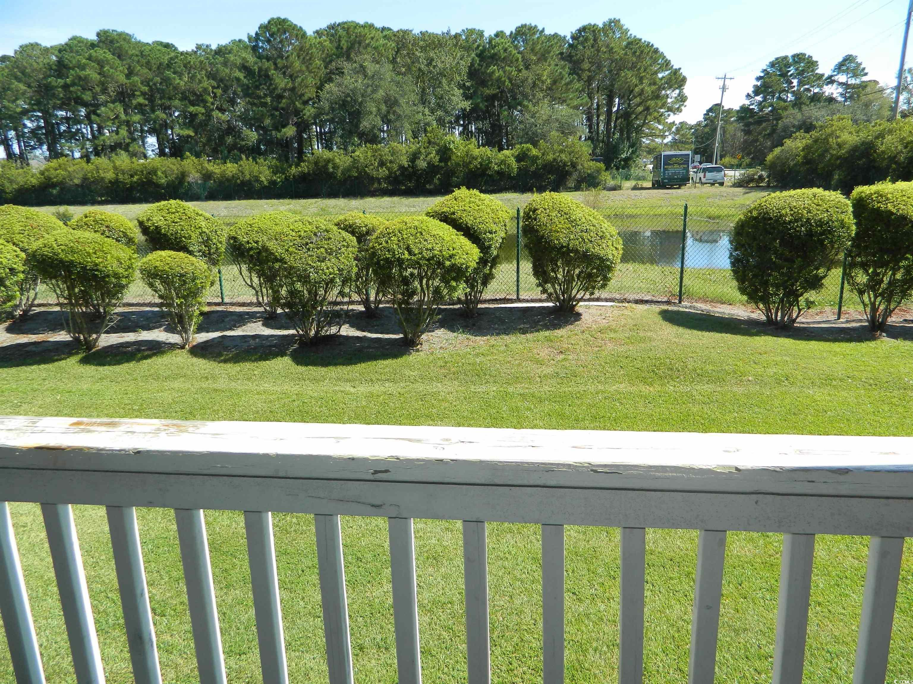 1356 Glenns Bay Road, Unit 103C Surfside Beach, SC 29575 - Photo 10 of 15 View of yard with a balcony and view of scattered trees