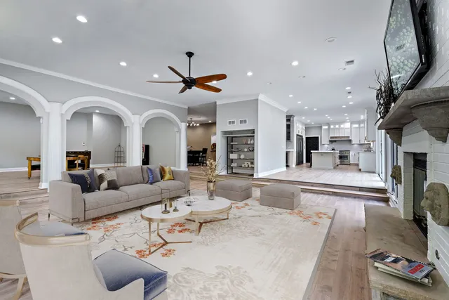 a living room with furniture and large windows