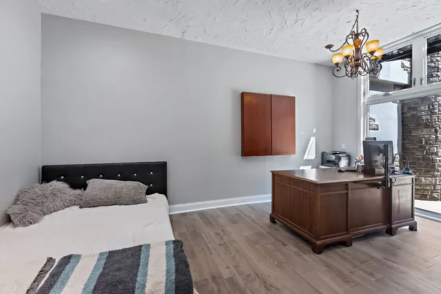 a spacious bedroom with a bed and a dresser