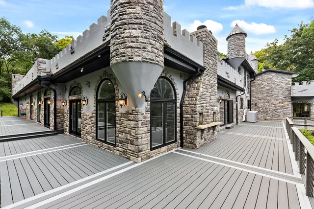 a front view of a house with swimming pool and sitting area