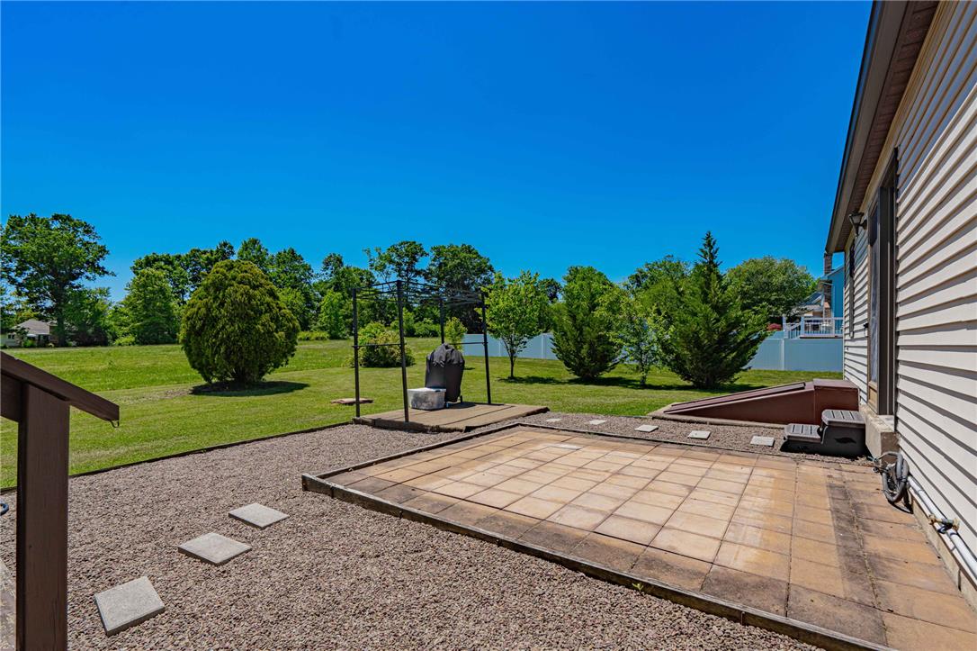 652 Old State Road Oley, PA 19547 - Photo 41 of 54 An inviting backyard patio offers ample space for outdoor entertaining with a lush, green lawn.