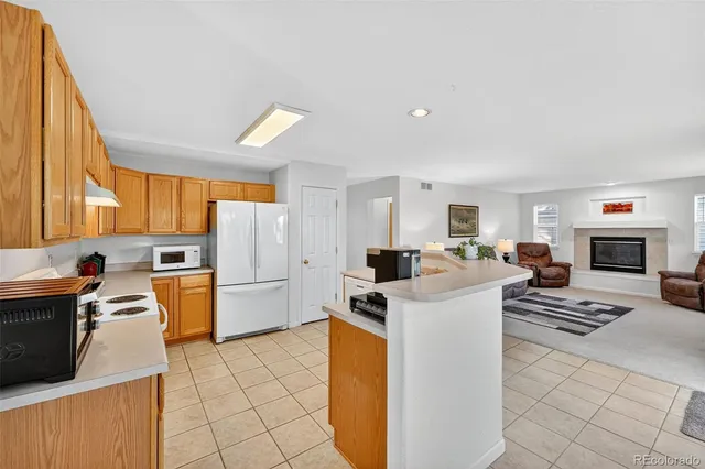 a kitchen with a white stove top oven and refrigerator