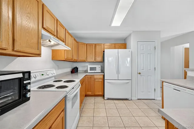 a kitchen that has a sink and a stove in it