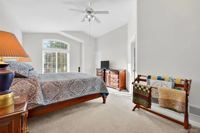 a bed room with a bed and a chair