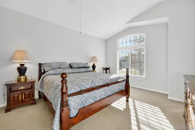 a spacious bathroom with a tub sink and mirror