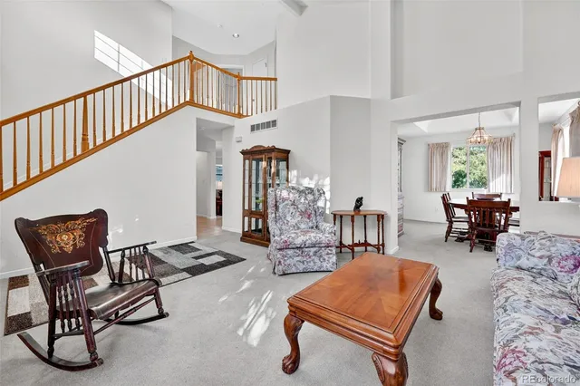 a living room with furniture gym equipment and a large window