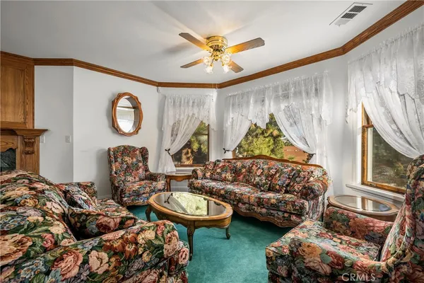 a bedroom with a bed and a dresser next to a window