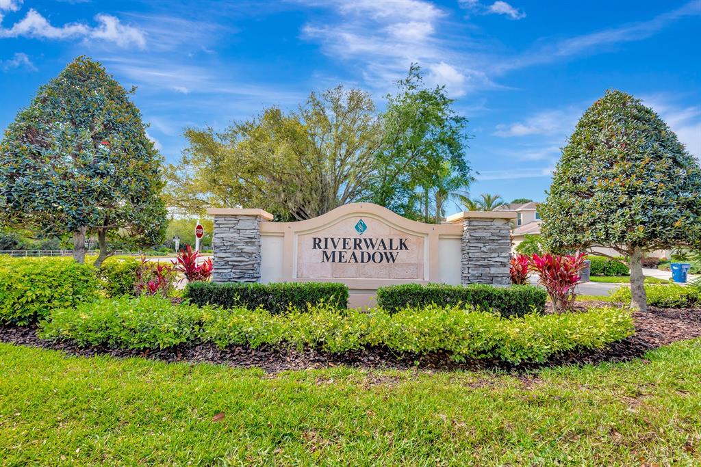 7344 Arrowhead Run Lakewood Ranch, FL 34202 - Photo 22 of 24 a sign that is sitting in front of flowers