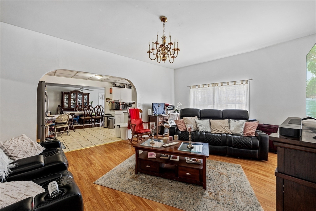 233 East Main Street Fall River, MA 02724 - Photo 13 of 29 a living room with furniture and a chandelier