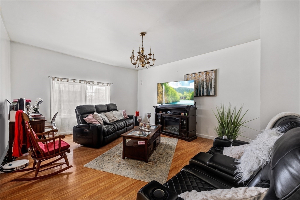 233 East Main Street Fall River, MA 02724 - Photo 14 of 29 a living room with furniture gym equipment and a flat screen tv