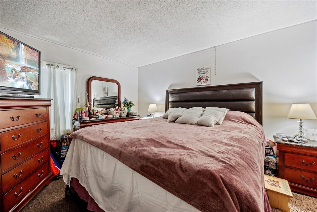 233 East Main Street Fall River, MA 02724 - Photo 18 of 29 a bedroom with a bed and a dresser in it