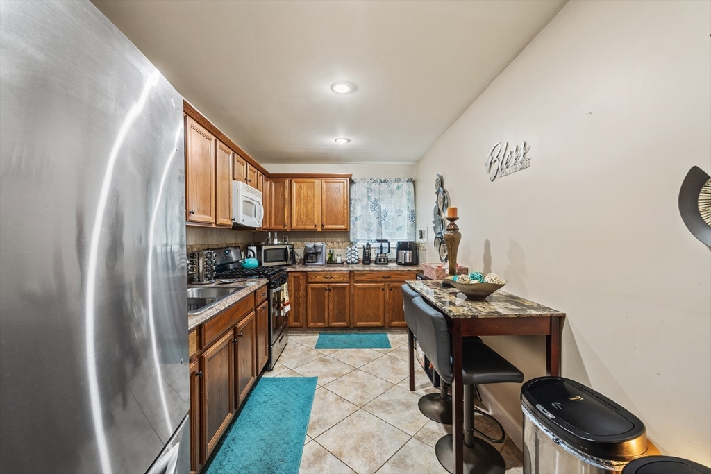 233 East Main Street Fall River, MA 02724 - Photo 4 of 29 a kitchen with a sink appliances and cabinets