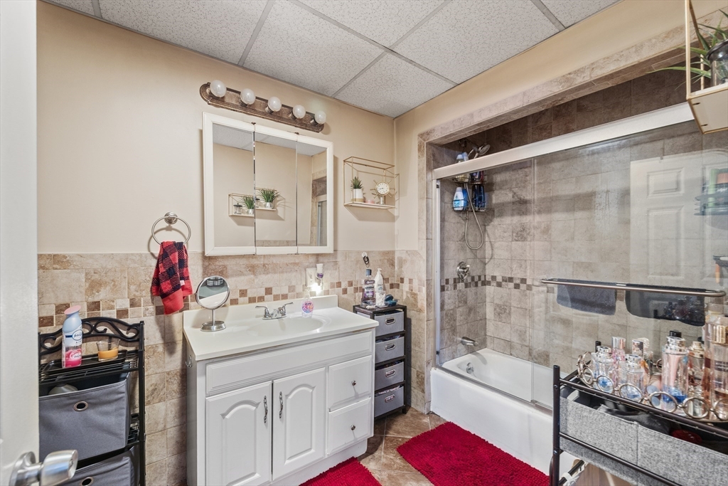 233 East Main Street Fall River, MA 02724 - Photo 10 of 29 a bathroom with a sink mirror vanity and bathtub