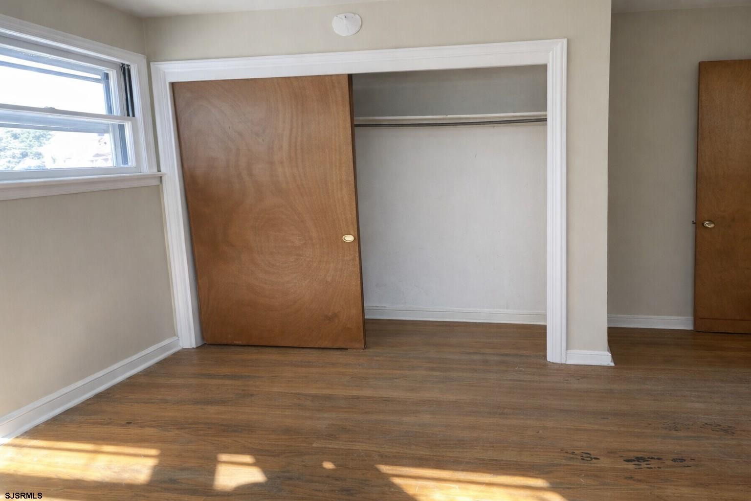 29 Summit Avenue Absecon, NJ 08201 - Photo 13 of 25 a view of an empty room with wooden floor and a window