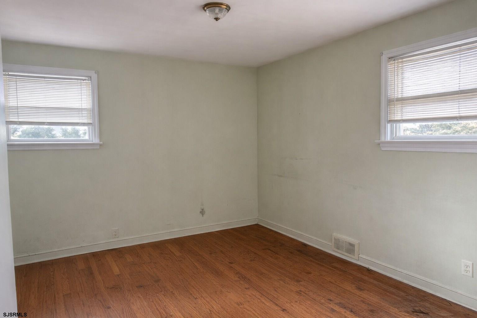 29 Summit Avenue Absecon, NJ 08201 - Photo 18 of 25 an empty room with wooden floor and windows