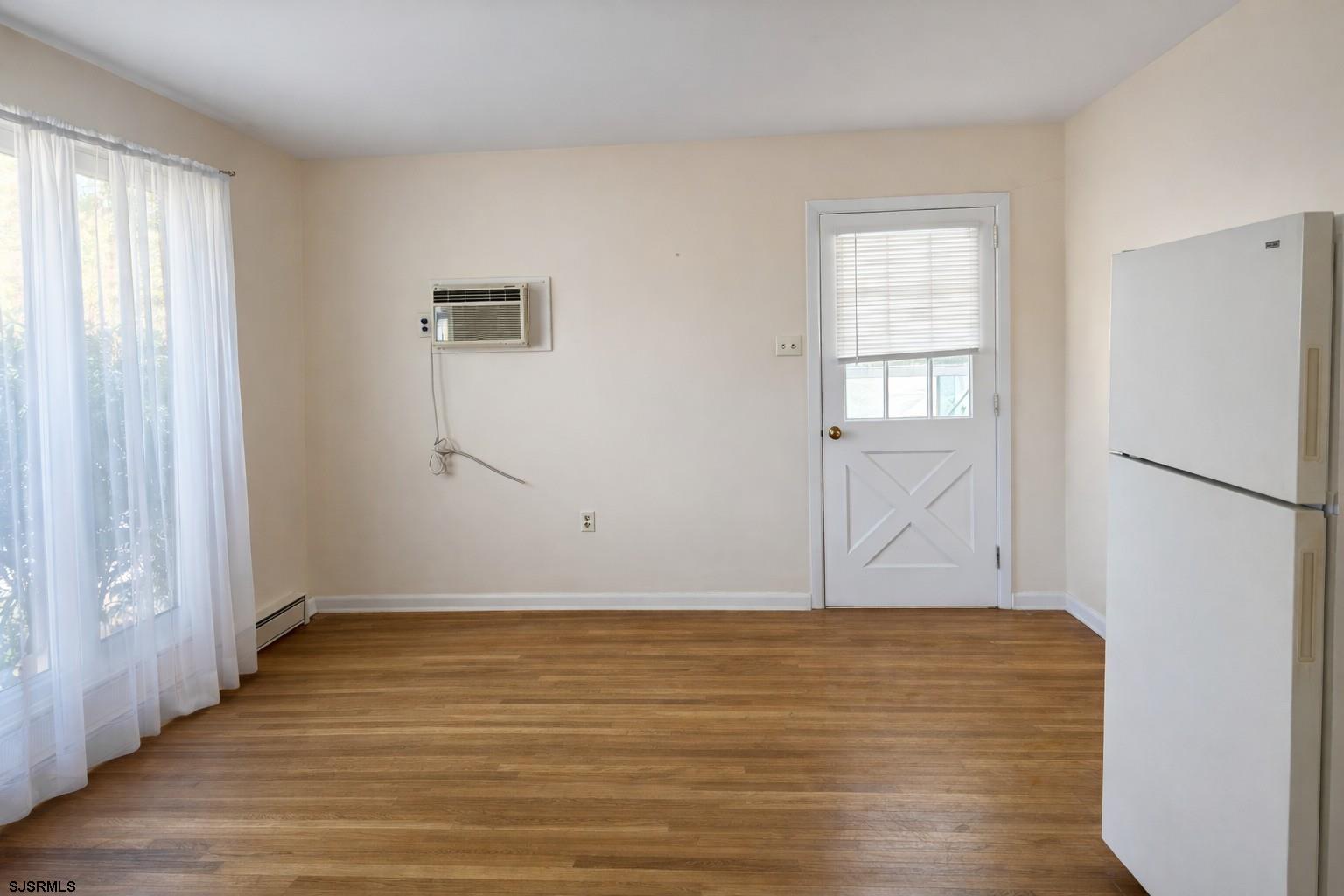 29 Summit Avenue Absecon, NJ 08201 - Photo 23 of 25 an empty room with wooden floor and windows