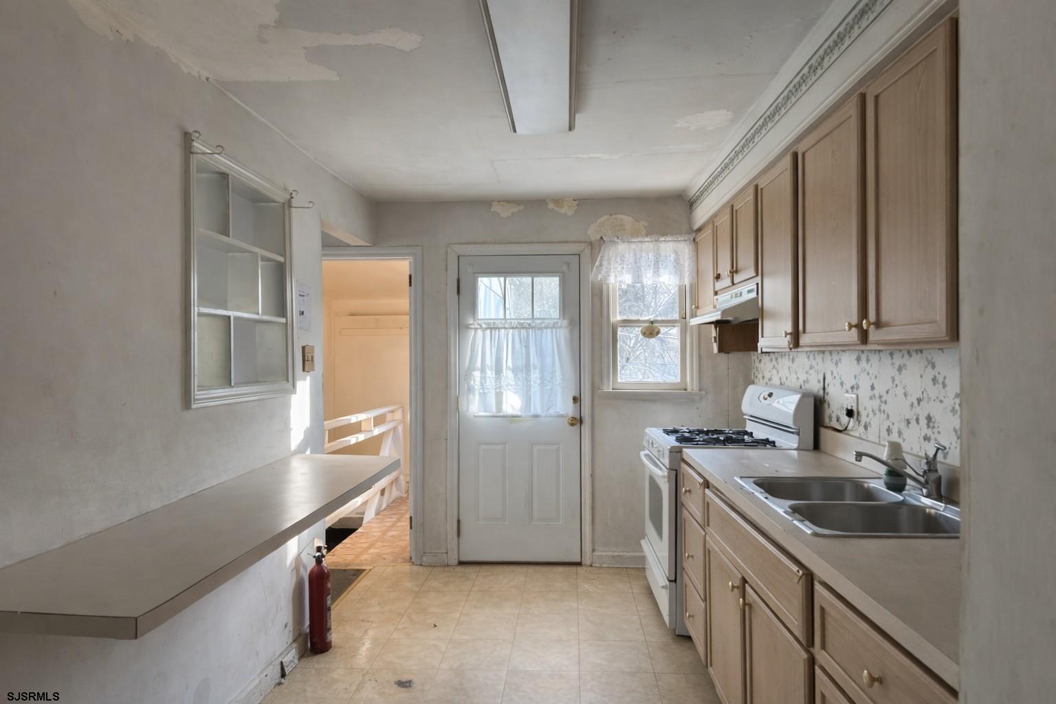 29 Summit Avenue Absecon, NJ 08201 - Photo 9 of 25 a kitchen with stainless steel appliances a sink stove and cabinets