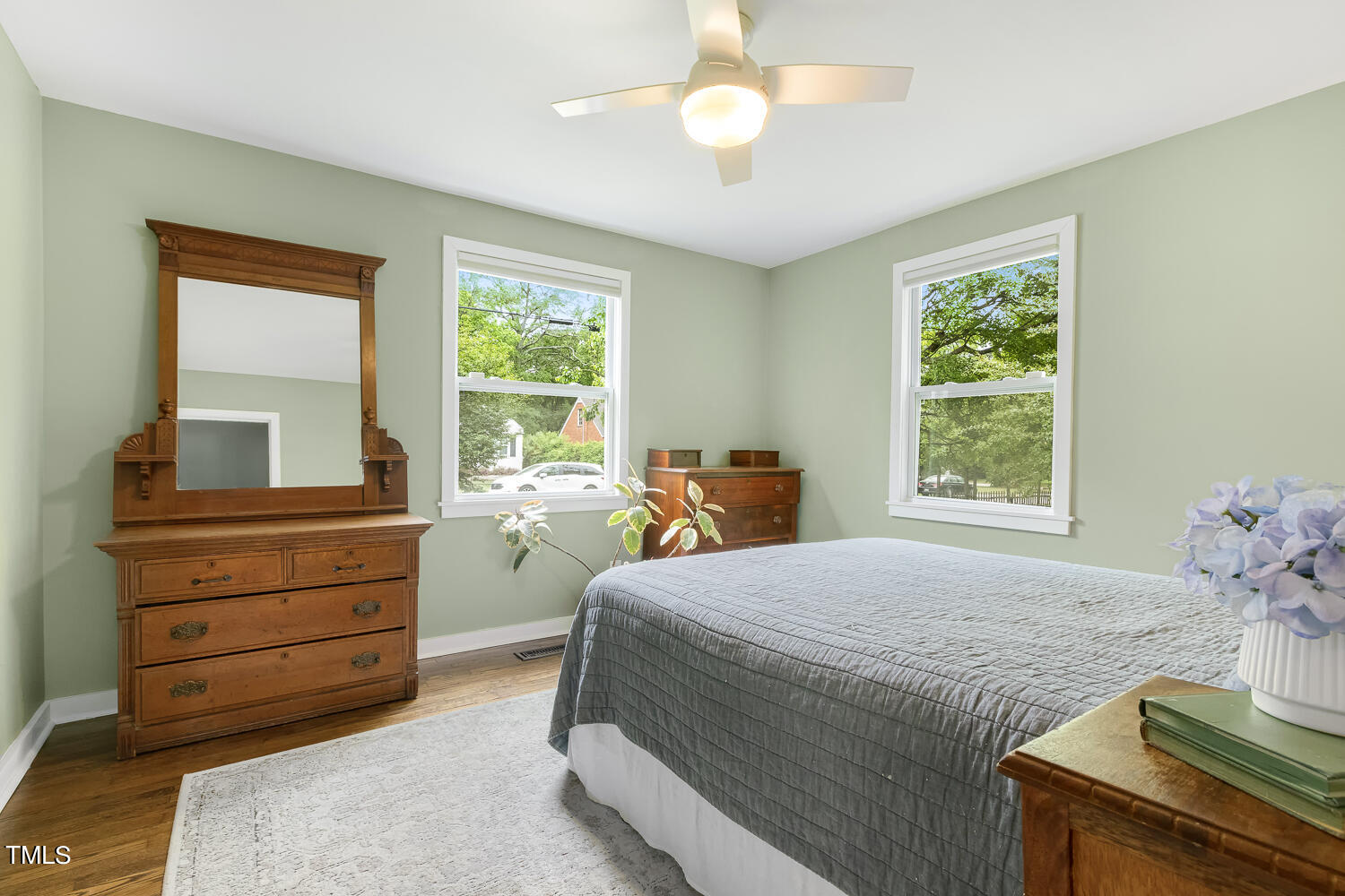 305 Colleton Road Raleigh, NC 27610 - Photo 8 of 17 a bedroom with a bed and large windows
