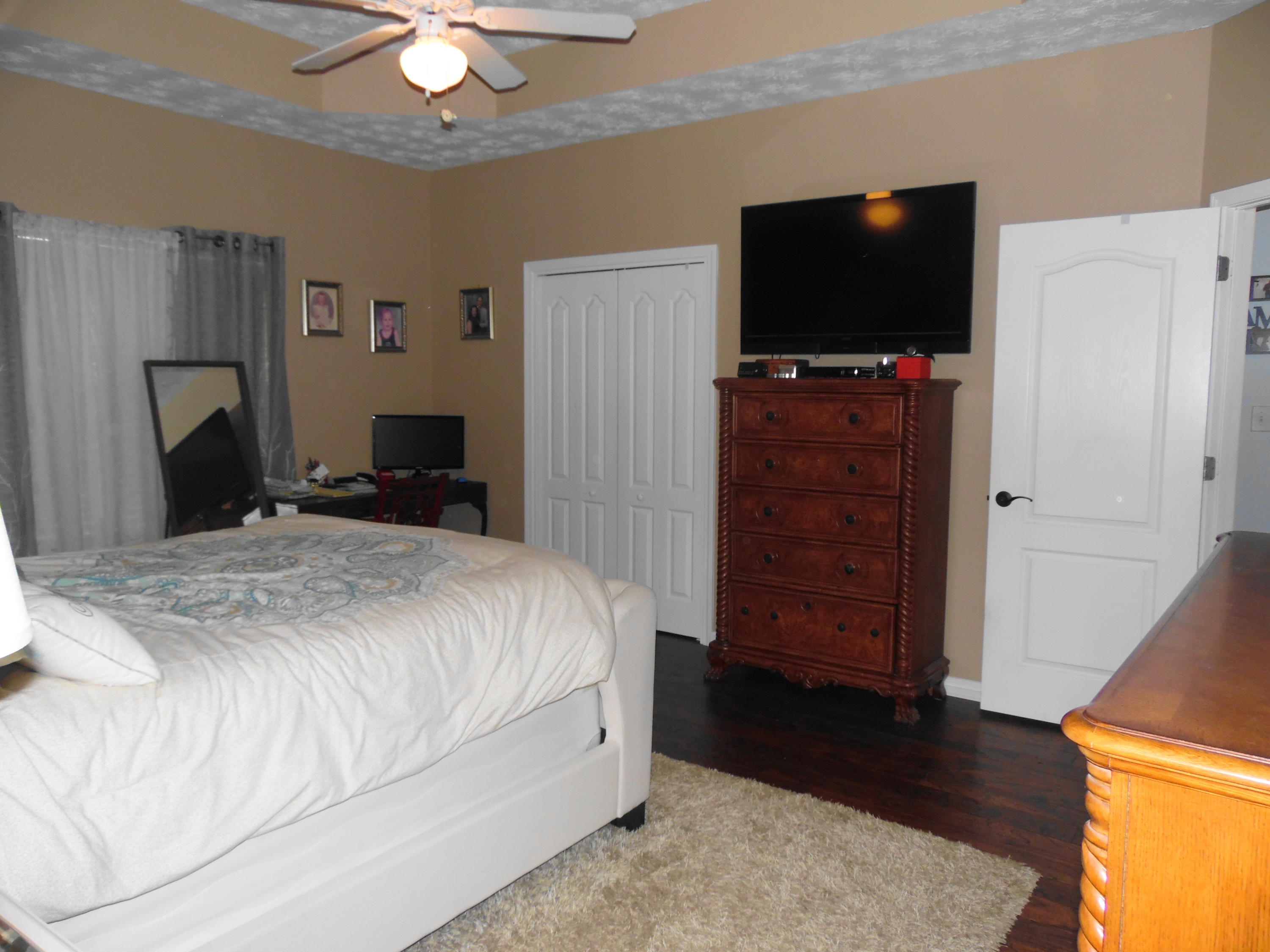 617 Tropical Way Freeport, FL 32439 - Photo 11 of 39 a bedroom with a bed and a flat screen tv