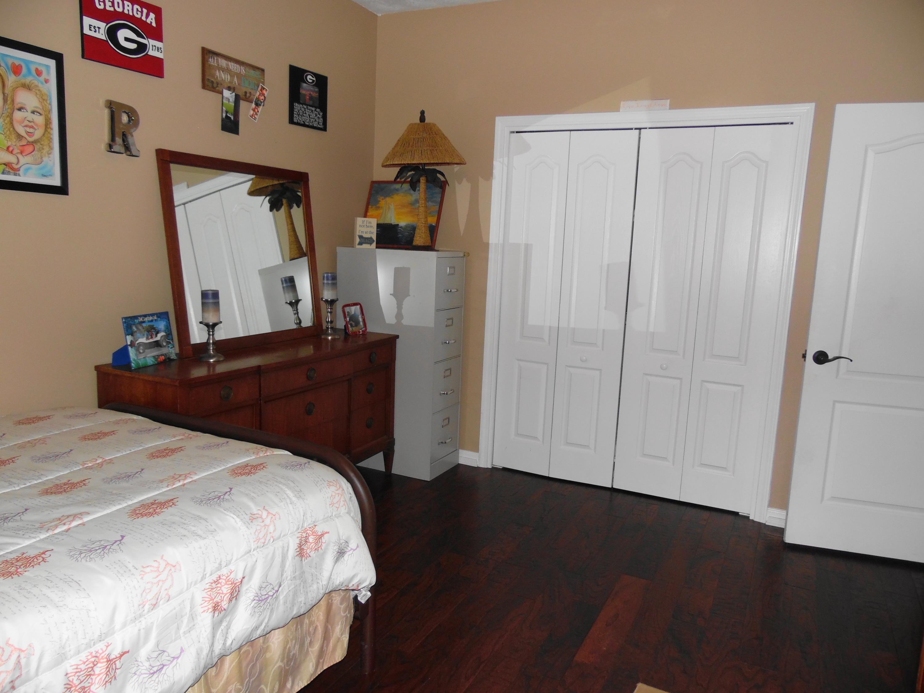 617 Tropical Way Freeport, FL 32439 - Photo 15 of 39 a bedroom with a bed and a dresser