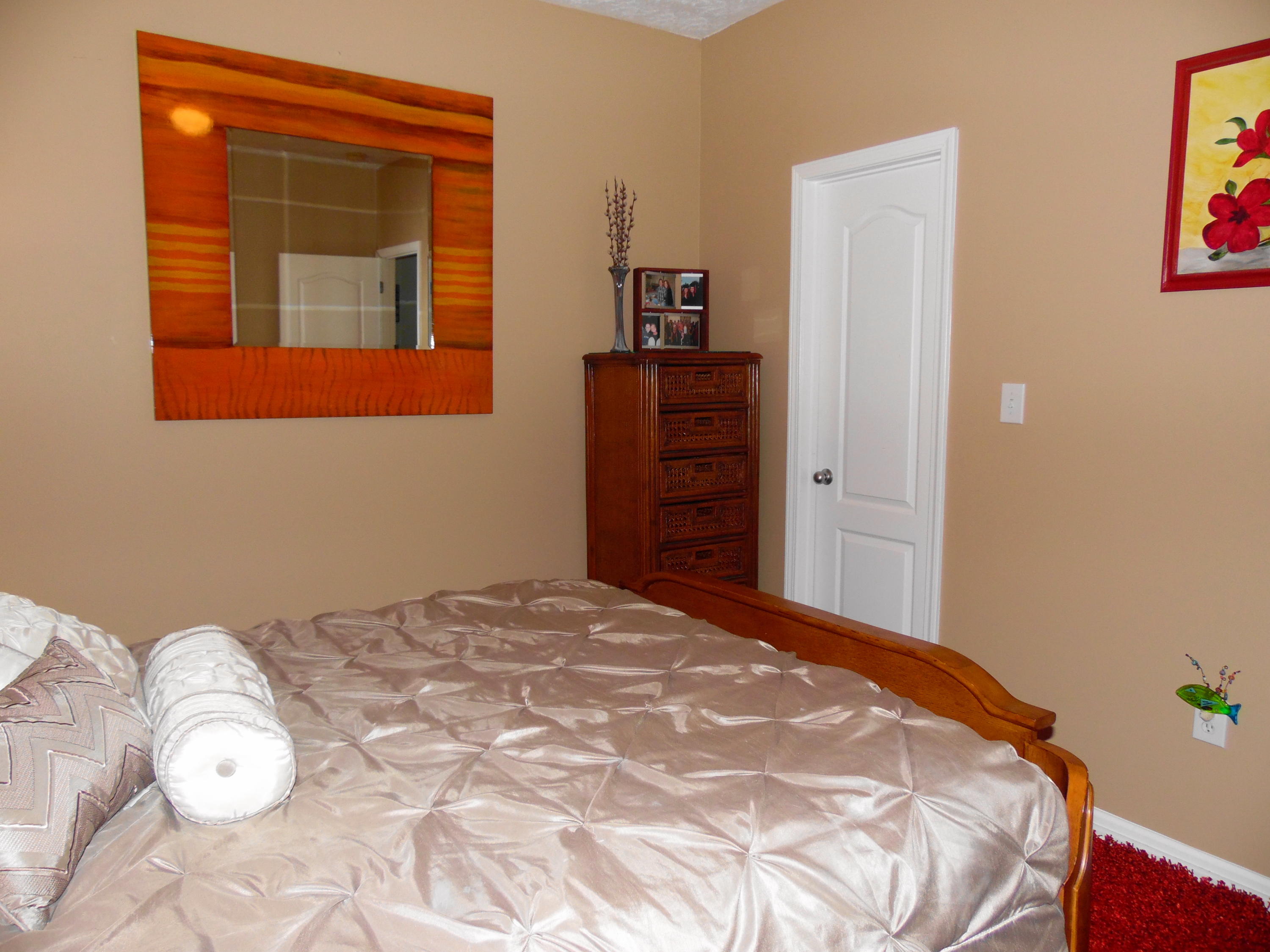 617 Tropical Way Freeport, FL 32439 - Photo 17 of 39 a bedroom with a bed and dresser