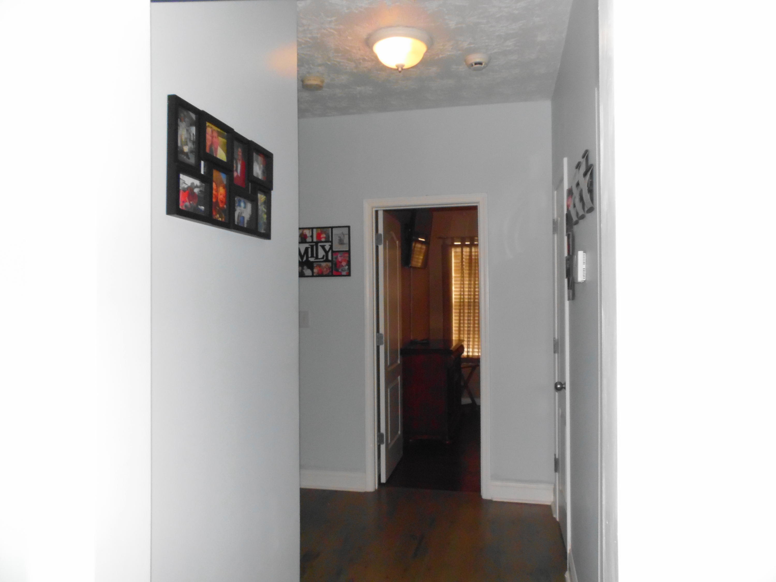 617 Tropical Way Freeport, FL 32439 - Photo 20 of 39 a view of a hallway with paintings on the wall