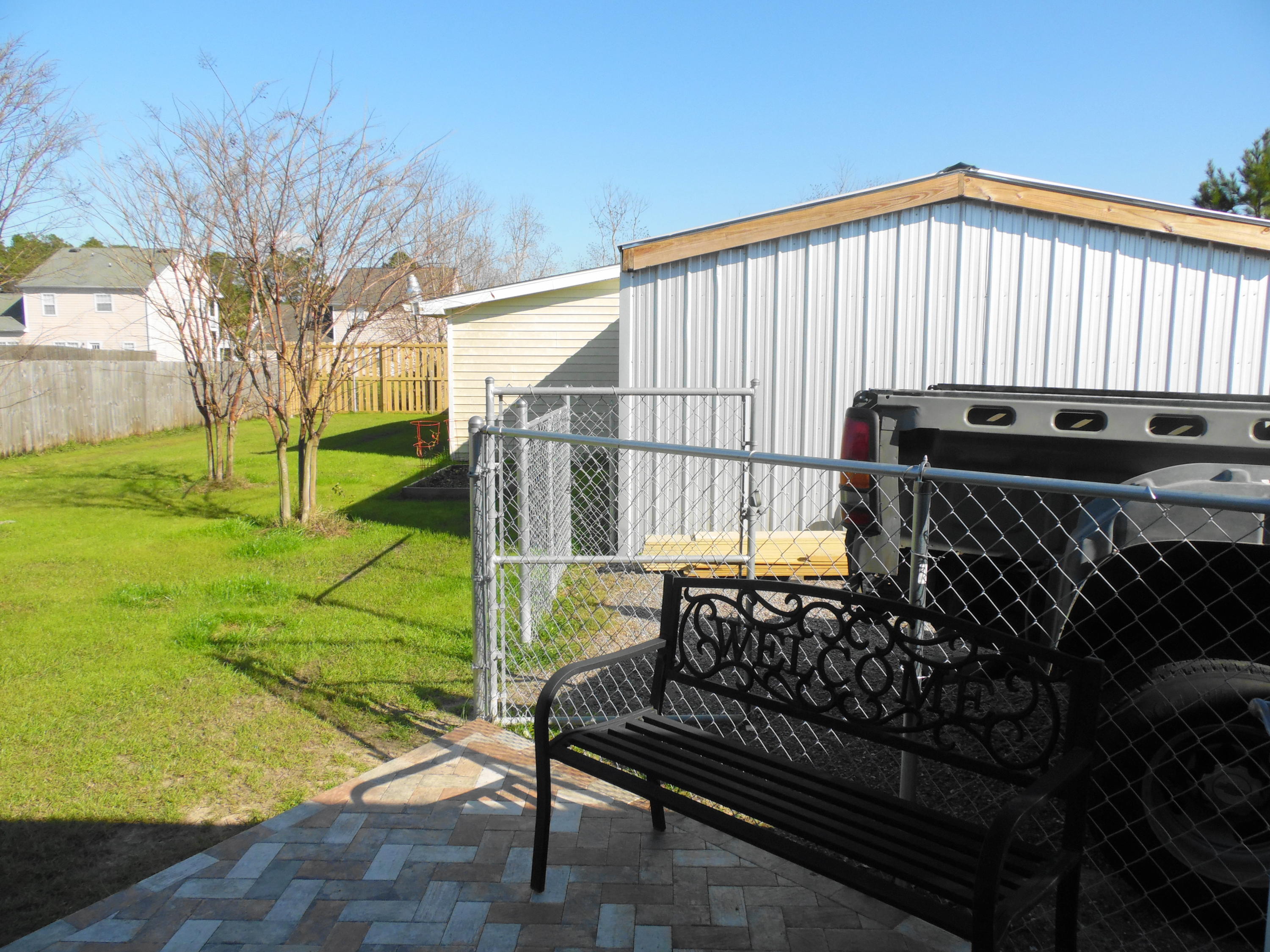 617 Tropical Way Freeport, FL 32439 - Photo 26 of 39 a view of a backyard with a bench