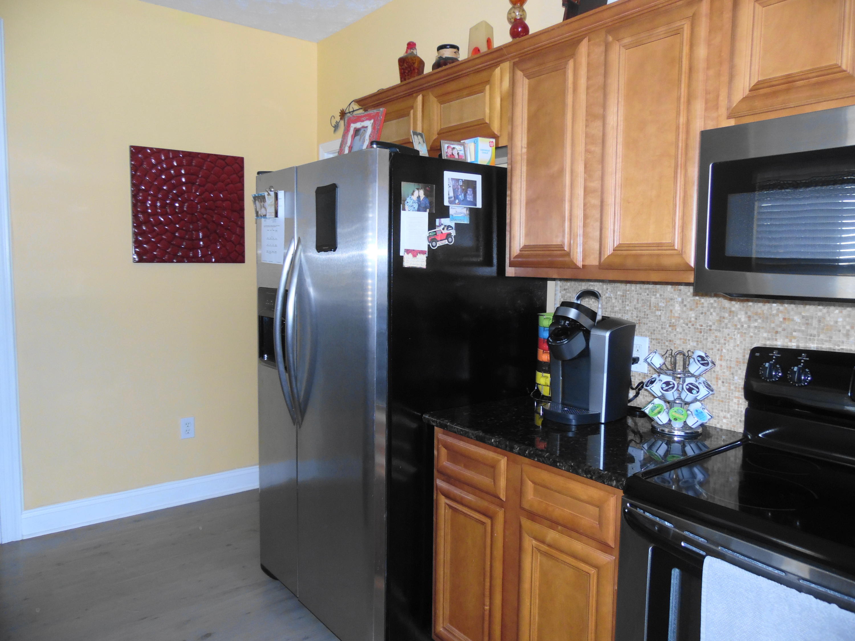 617 Tropical Way Freeport, FL 32439 - Photo 4 of 39 a kitchen with stainless steel appliances granite countertop a refrigerator and a stove
