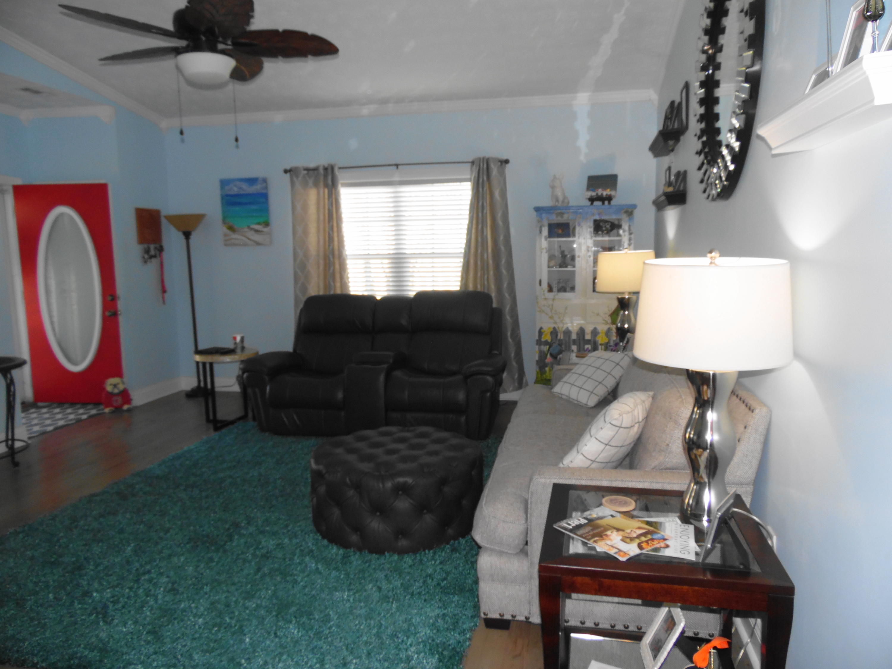 617 Tropical Way Freeport, FL 32439 - Photo 8 of 39 a living room with furniture a window and a chandelier