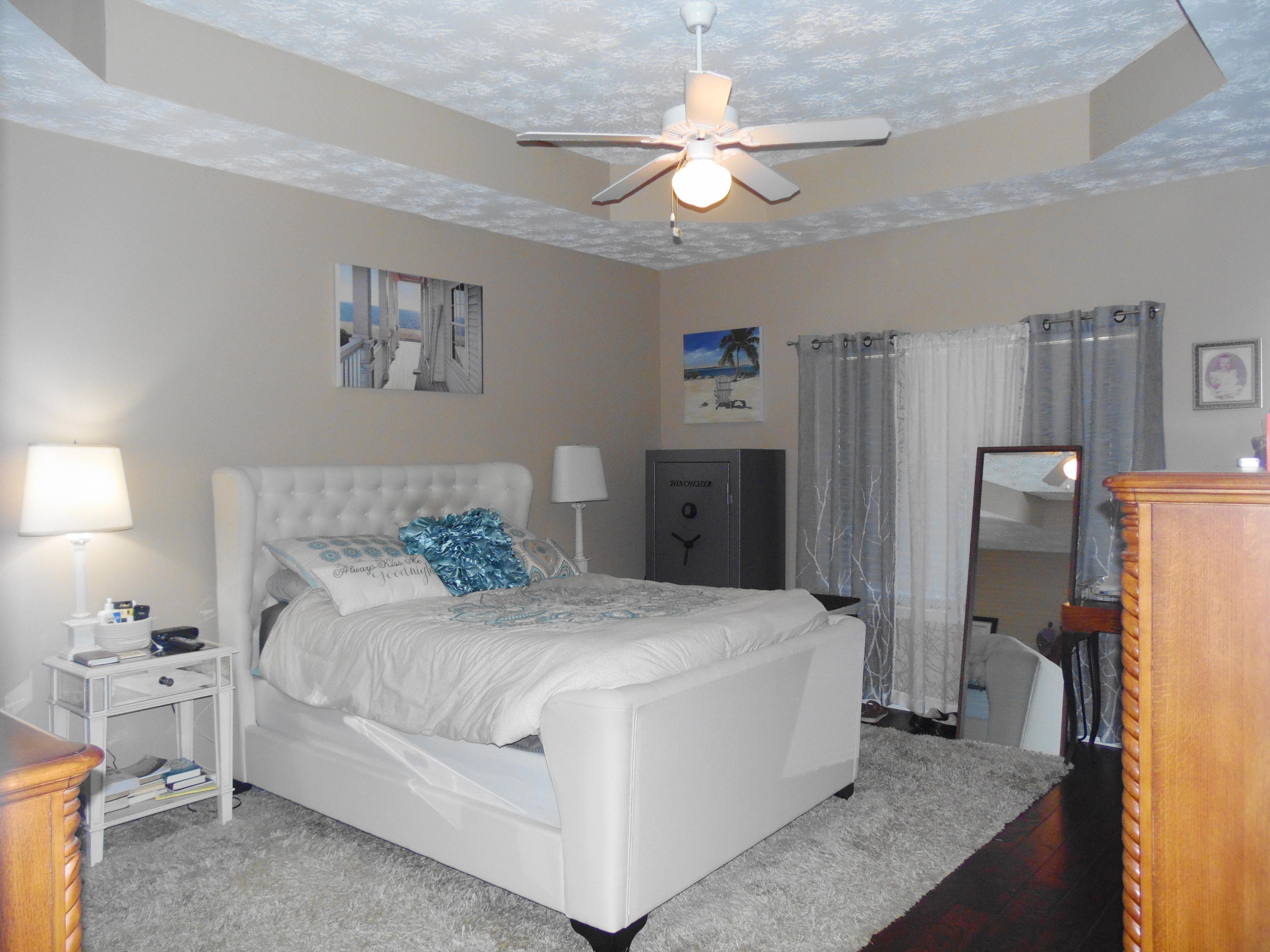 617 Tropical Way Freeport, FL 32439 - Photo 10 of 39 a bedroom with a bed and a chandelier