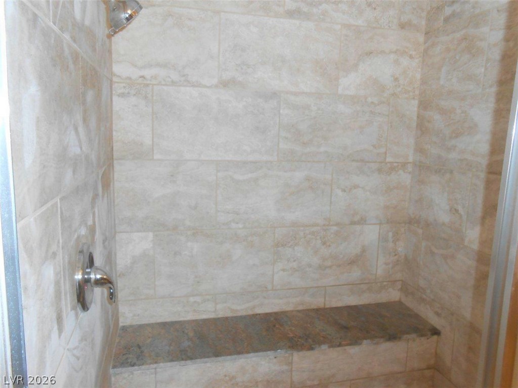 9325 West Desert Inn Road, Unit 132 Las Vegas, NV 89117 - Photo 10 of 36 A generously sized shower with a convenient built-in bench for enhanced comfort.
