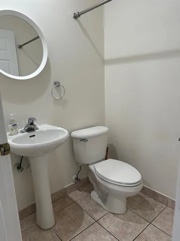 a white toilet sitting next to a bathroom sink