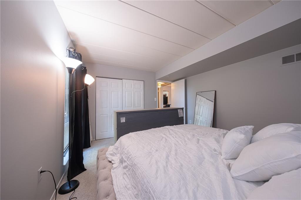 2034 Swallow Hill Road, Unit 326 Pittsburgh, PA 15220 - Photo 13 of 28 a large bed in a white room with closet