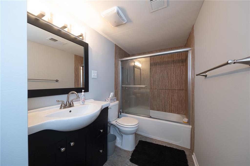 2034 Swallow Hill Road, Unit 326 Pittsburgh, PA 15220 - Photo 14 of 28 a bathroom with a sink a toilet and shower